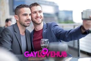 A happy gay couple taken selfies for their free dating profile on Gay Love Hub website.