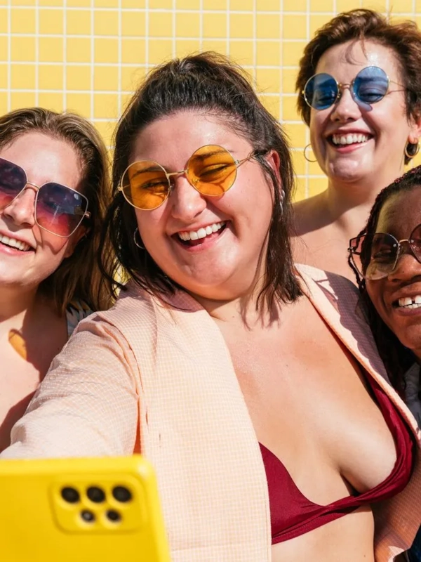 A group of chubby and curvy friends laughing together