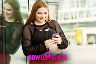 Woman smiling while setting up her BBW Love Hub profile on a dating site.