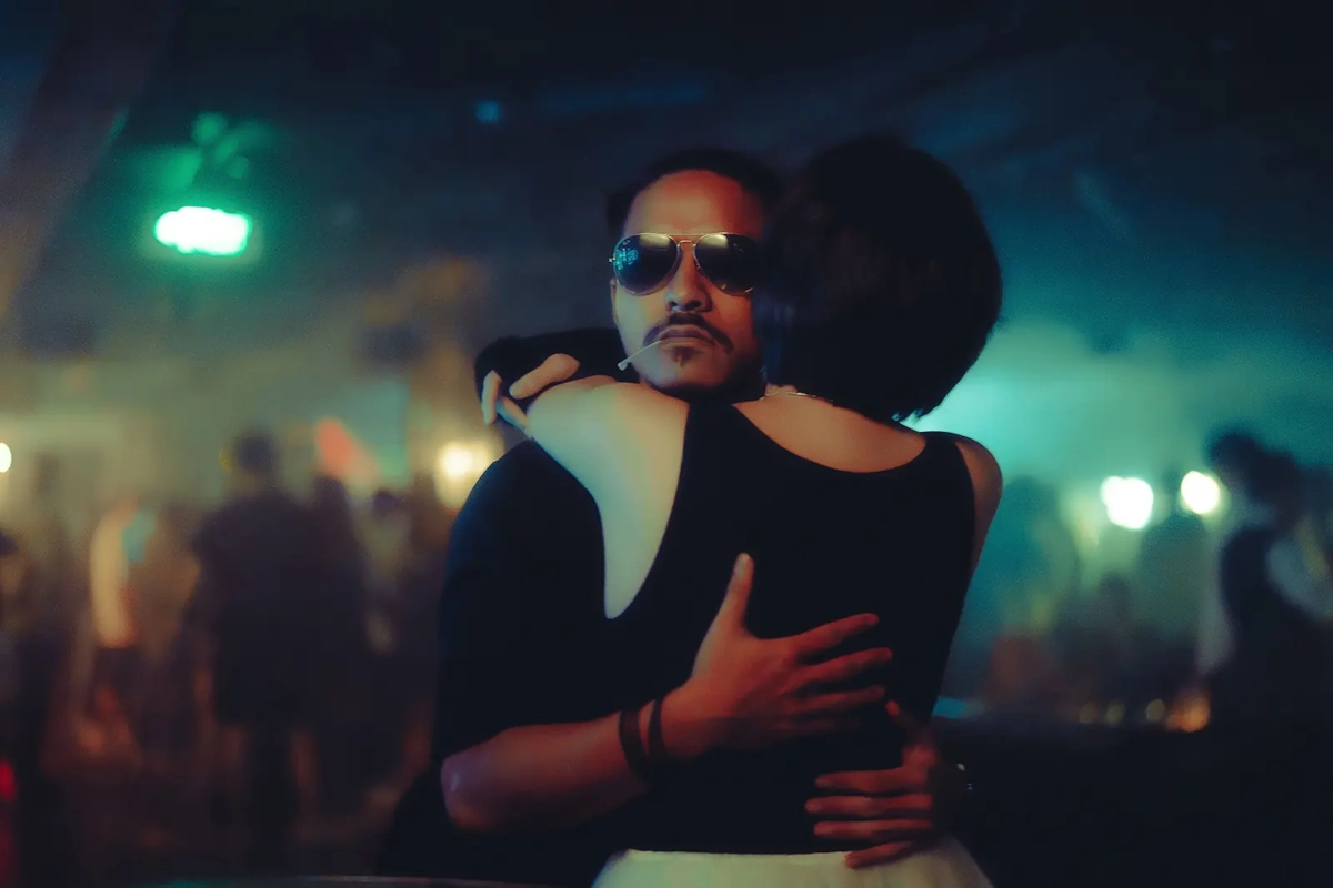 Couple embracing on a busy dance floor during a night out