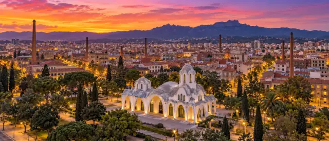 Terrassa al atardecer con la Masia Freixa iluminada, chimeneas industriales y La Mola al fondo