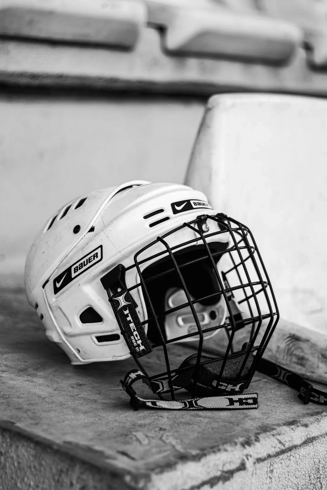 A white helmet sitting on an empty team bench