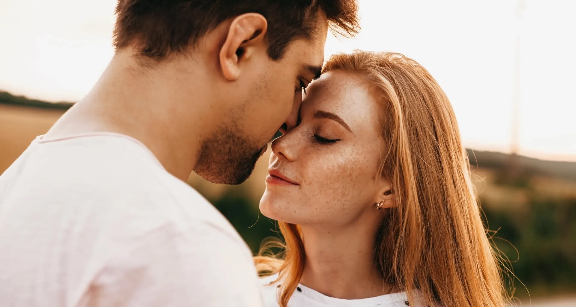 Adult couple sharing a close moment outdoors