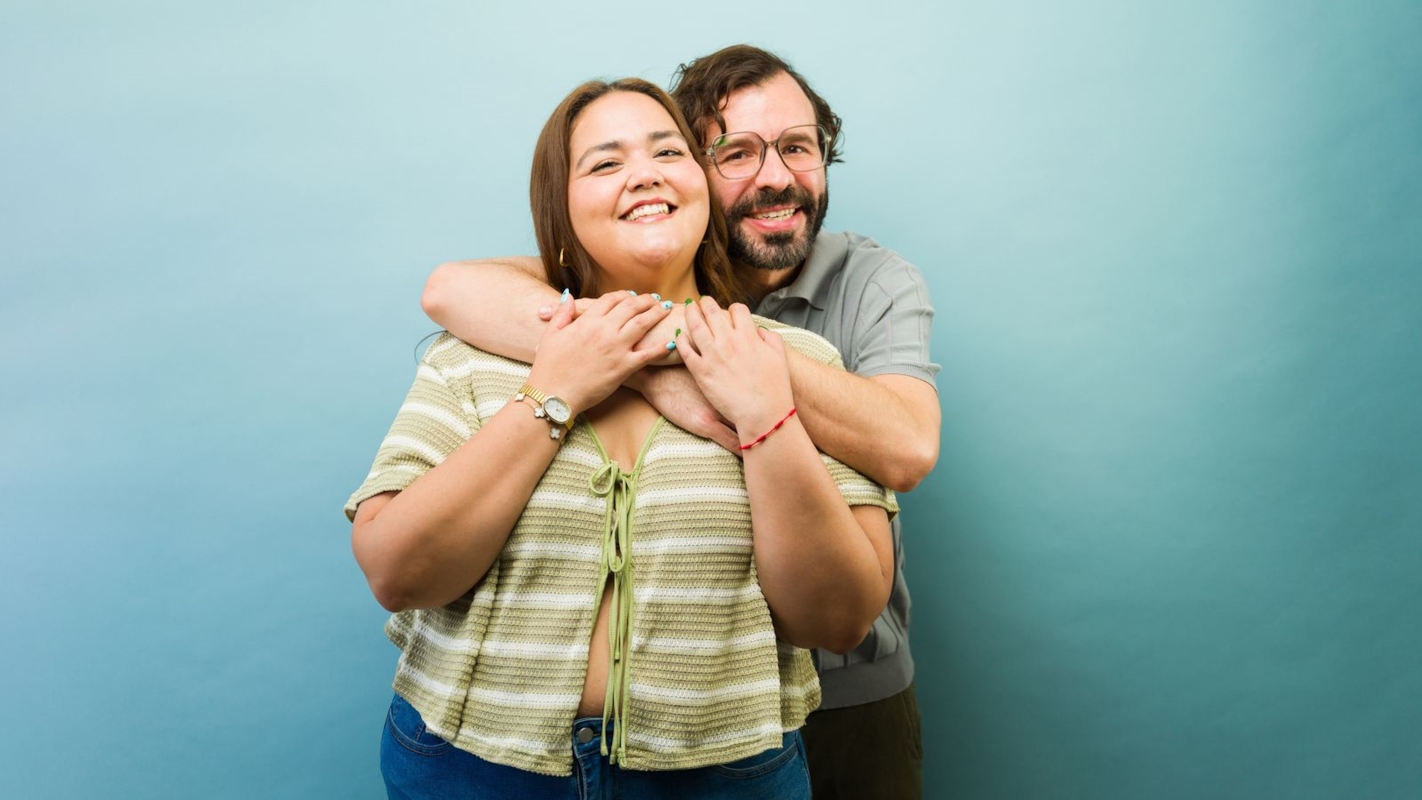 A couple laughing together and embracing warmly