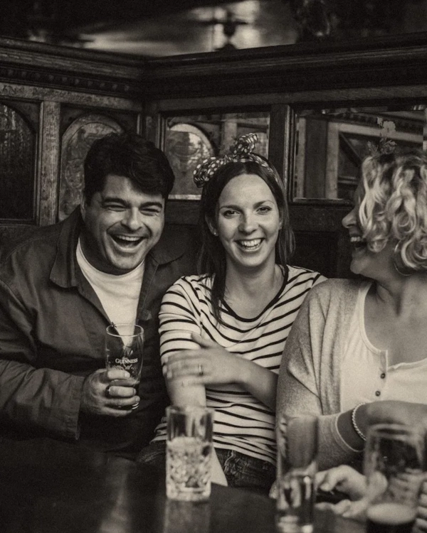 Friends laughing together in a pub