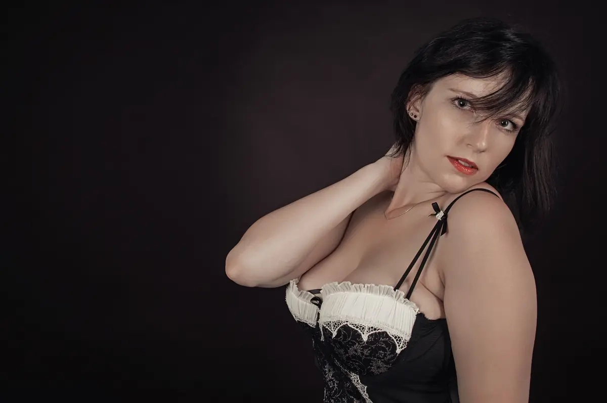 Illustrative stock portrait of a mature female model in a dark studio