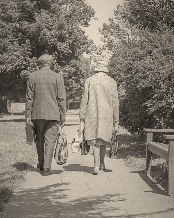 Older couple walking together along a park path