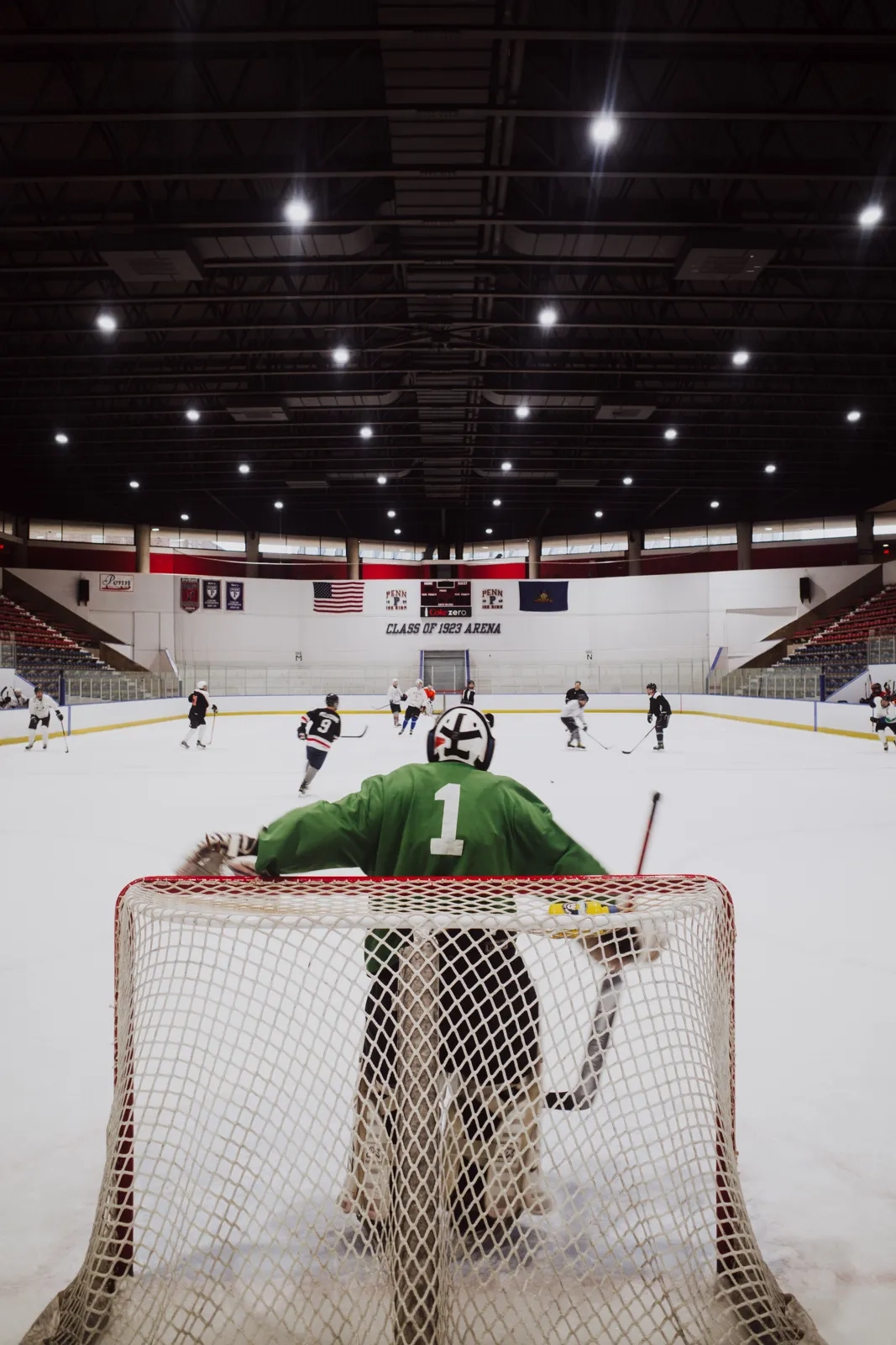 A goalie waiting in net in a quiet arena