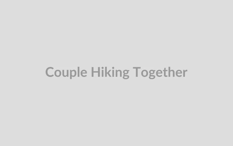 Active couple hiking on a scenic mountain trail together