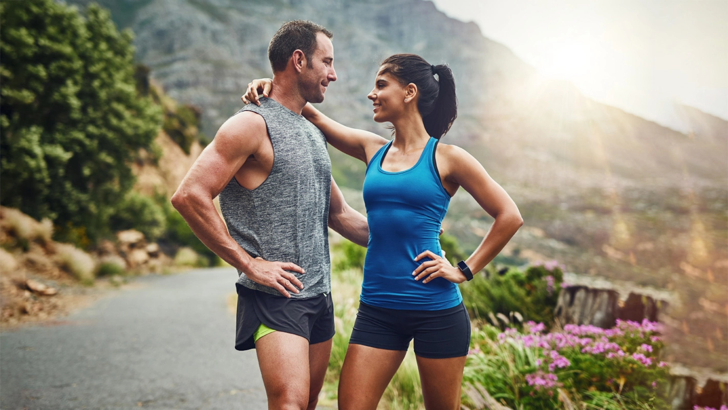 Fit couple enjoying outdoor workout together on a scenic trail
