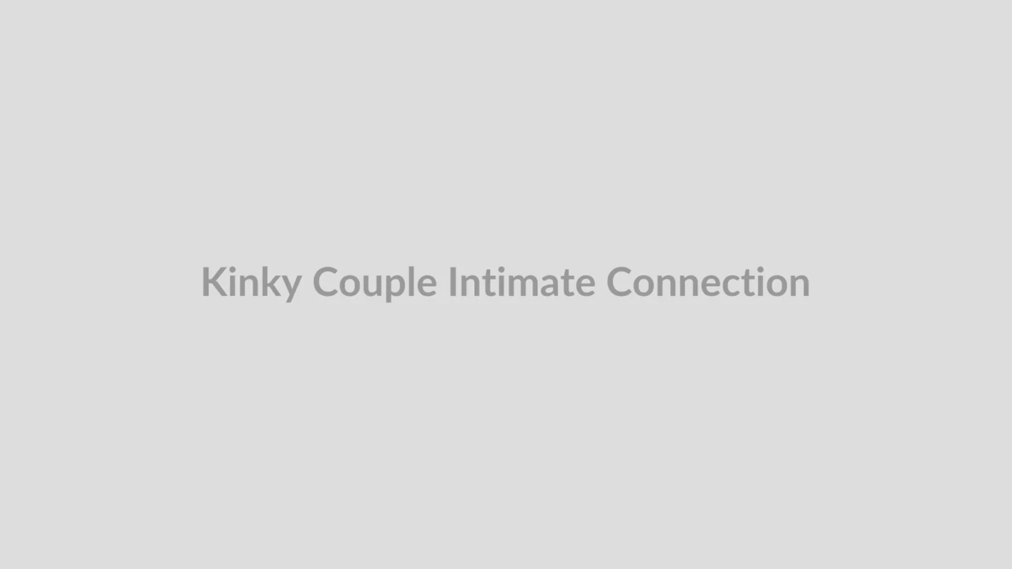 Intimate couple sharing a playful moment in a dimly lit lounge setting