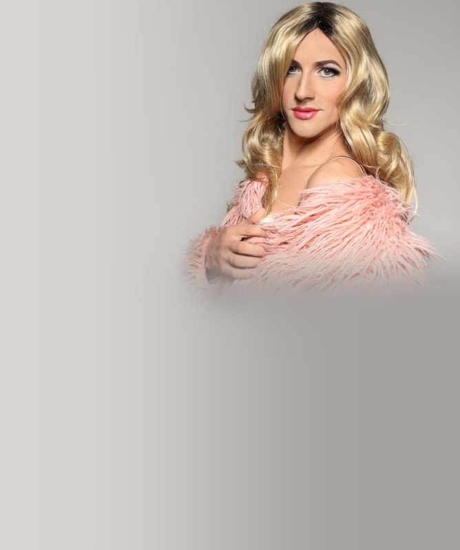 Illustrative photo of a crossdresser in a pink faux-fur wrap. Not an actual member.
