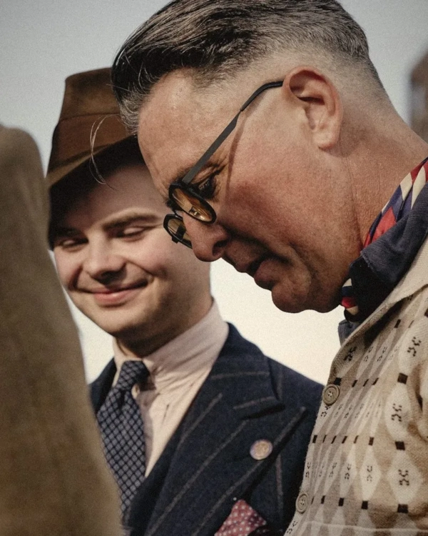 Two smiling men in tweed and flat caps