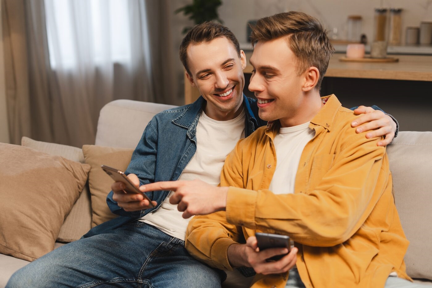 A Gaydar member browsing profiles on his phone at home