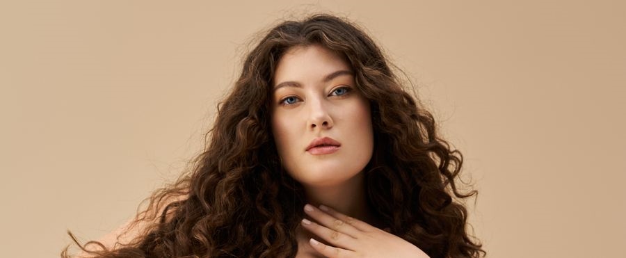 A confident curvy woman with curly hair