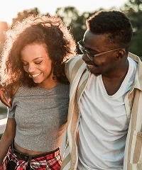 A young couple walking arm in arm outdoors