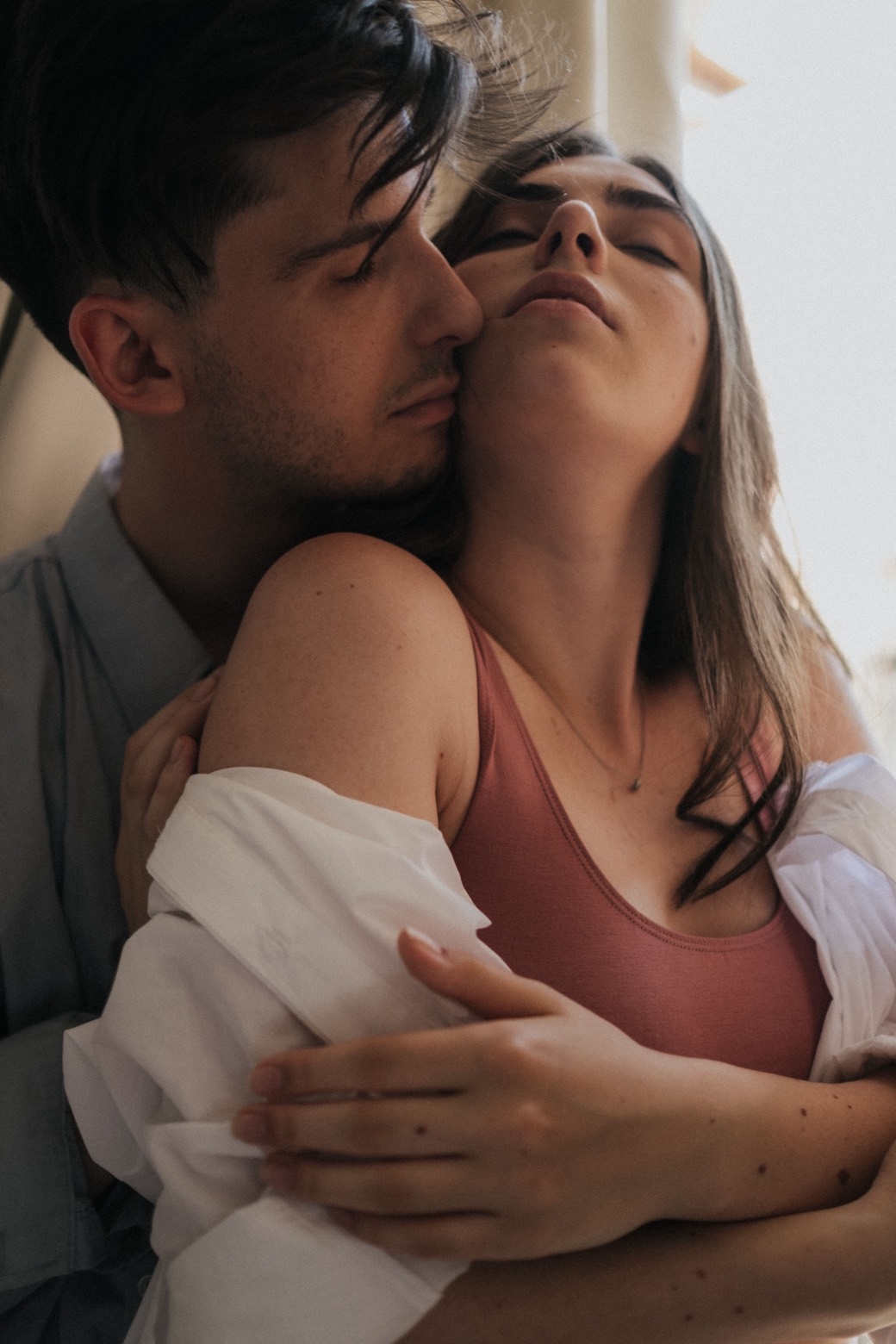 Illustrative stock photo of two adults in a close nuzzle. Does not depict real members.