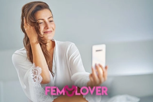 Beautiful Woman creating her FEM Lover lesbian profile on phone, smiling with excitement.