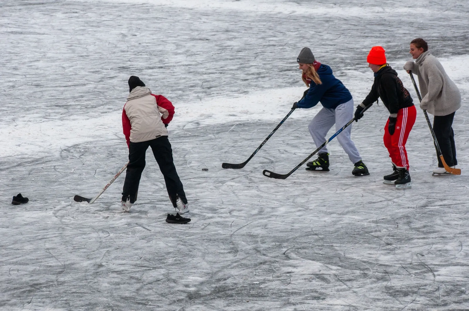 A pickup hockey game on outdoor pond ice