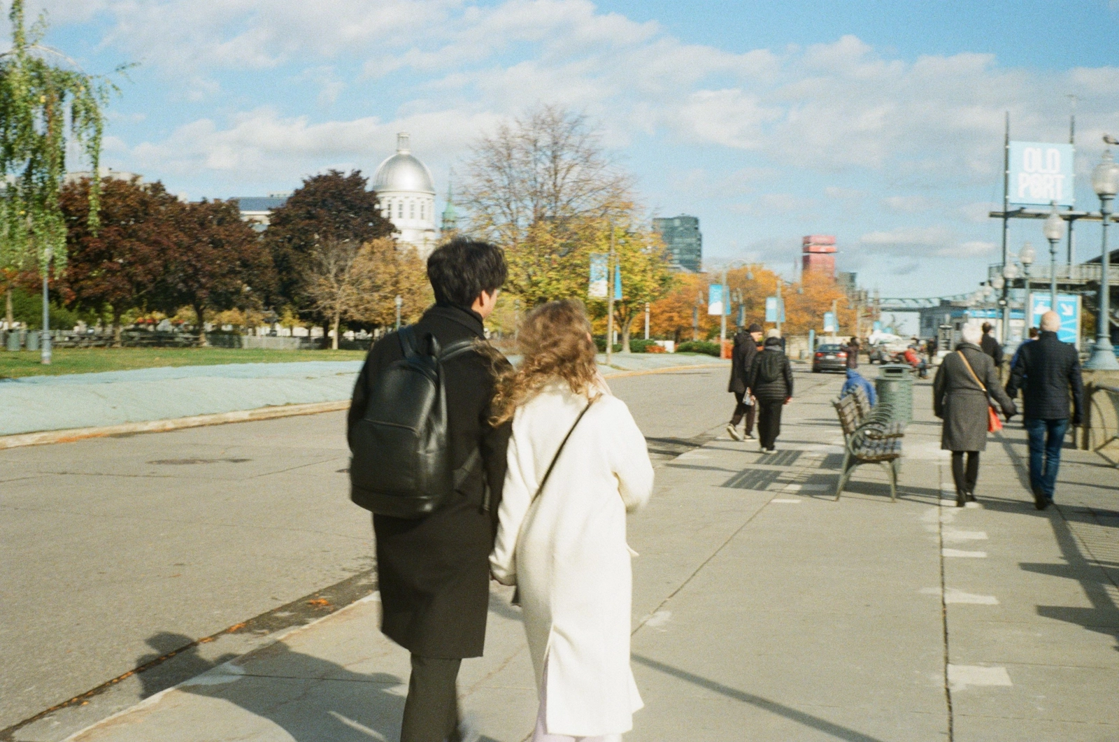 Couple strolling down a city street on an autumn day