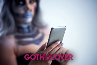 Goth woman creating dating profile on GOTH Lover dark-themed site.