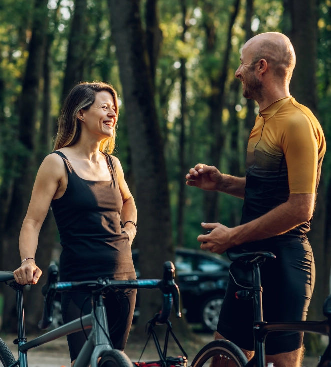 Couple pausing their bike ride to talk and enjoy the outdoors together.