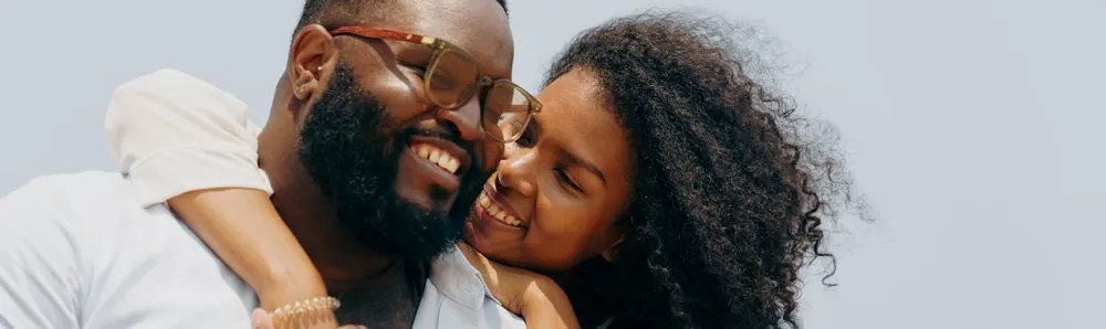 A couple embracing and smiling together