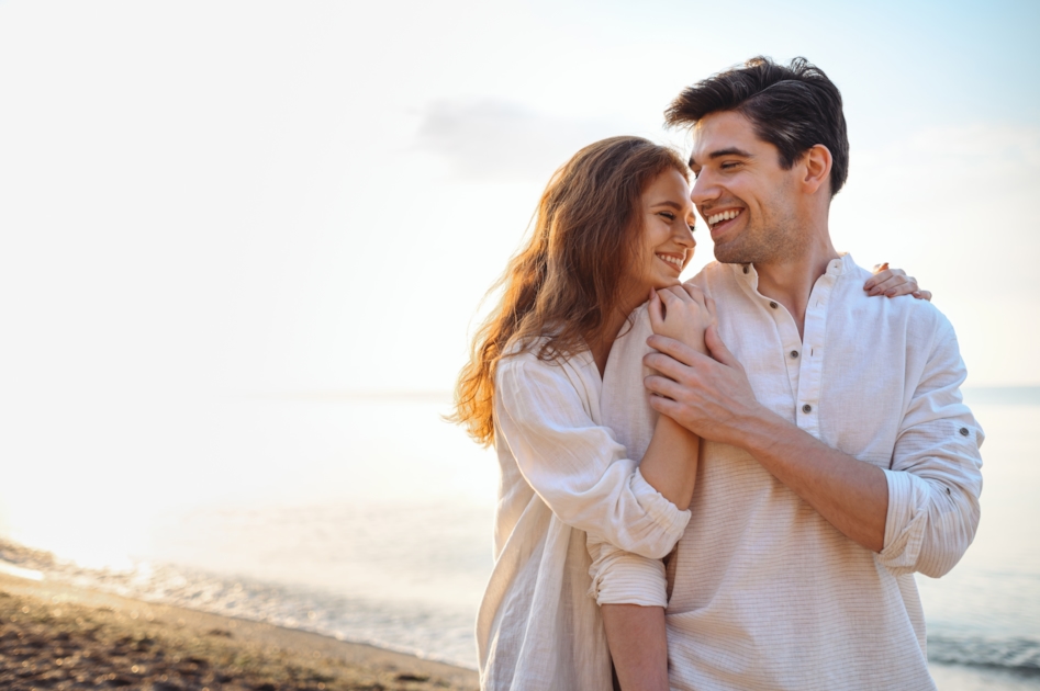 Couple embracing on a beach at sunset