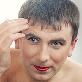 Illustrative photo of a crossdresser applying makeup. Not an actual member.