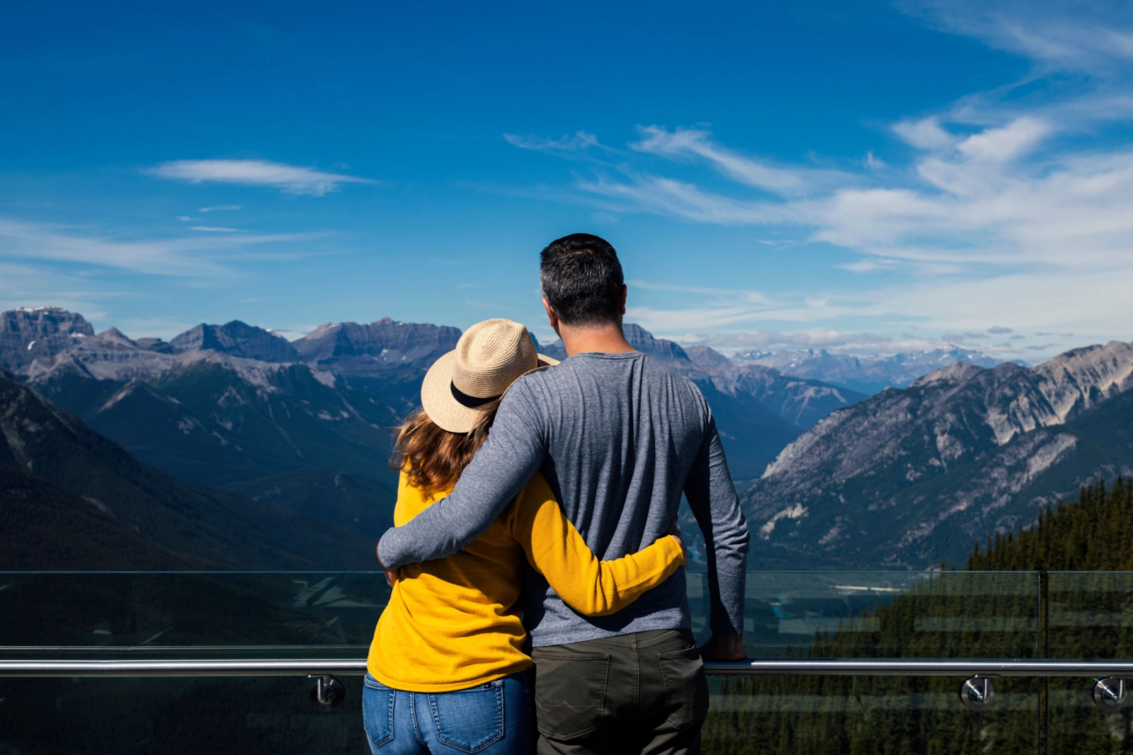 Couple embracing at a mountain lookout above a valley
