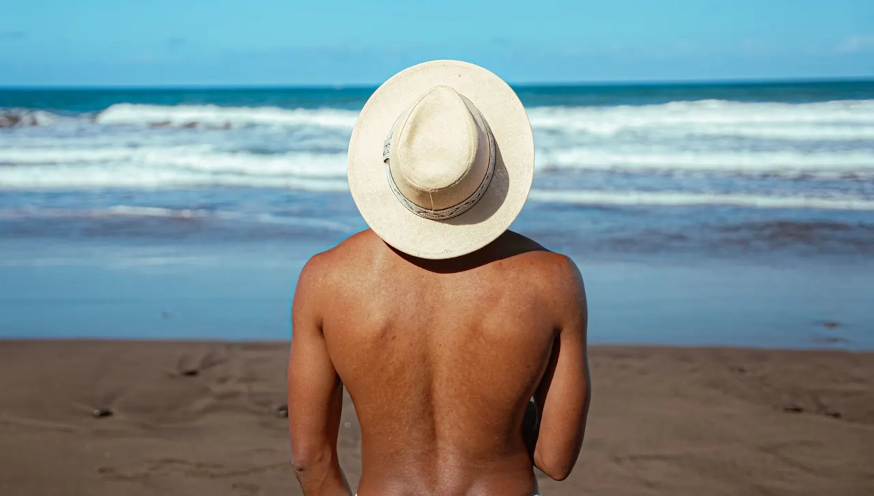 Illustrative stock photograph of an adult looking toward the sea