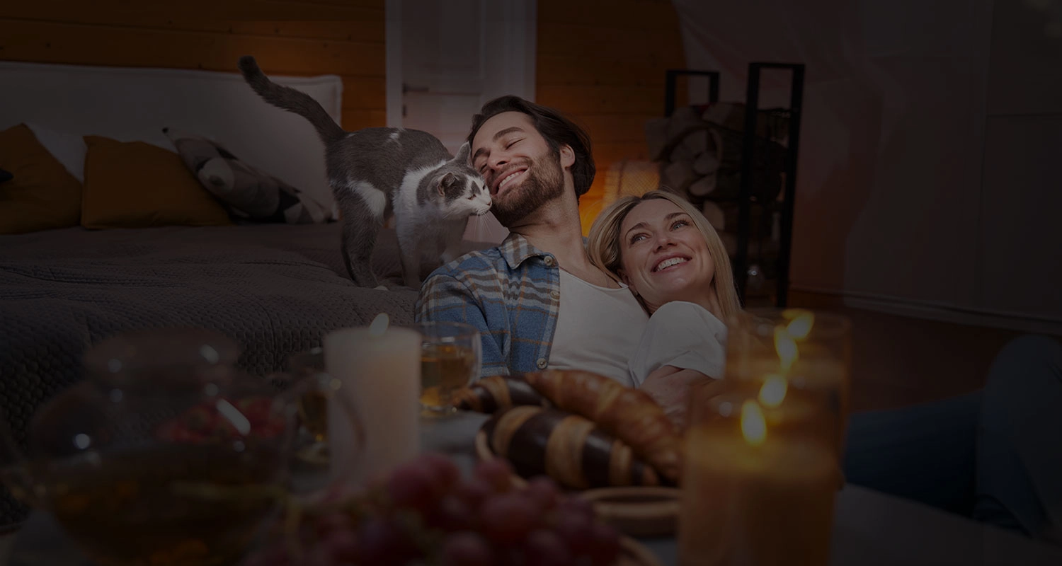 Happy cat loving owners sharing a relaxing time together with their cat after meeting on Cat Love Hub.