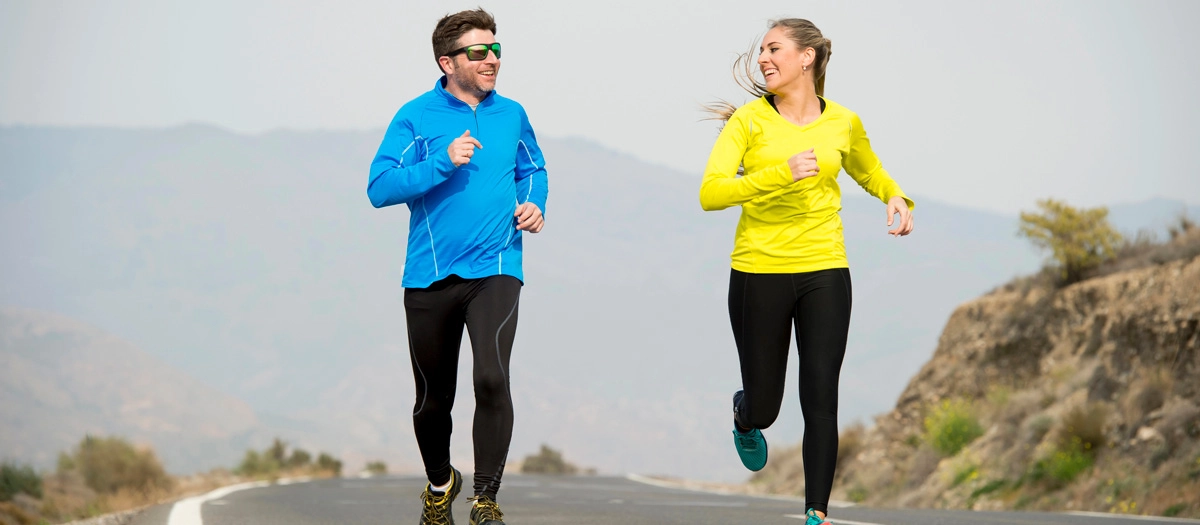 A couple running together outdoors