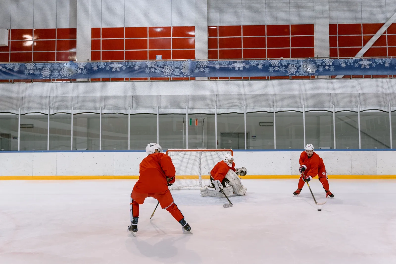Rec-league skaters crossing sticks in front of the goal crease