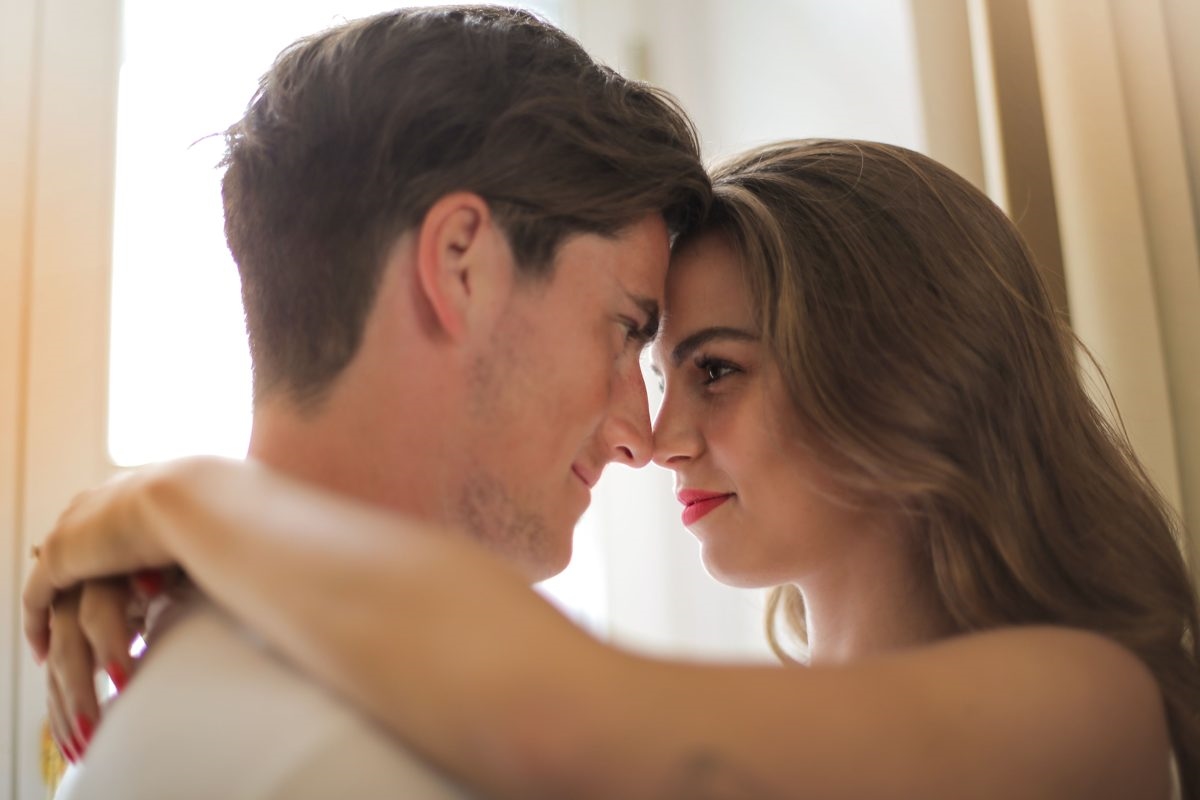 Couple resting foreheads together, relaxed and familiar with each other
