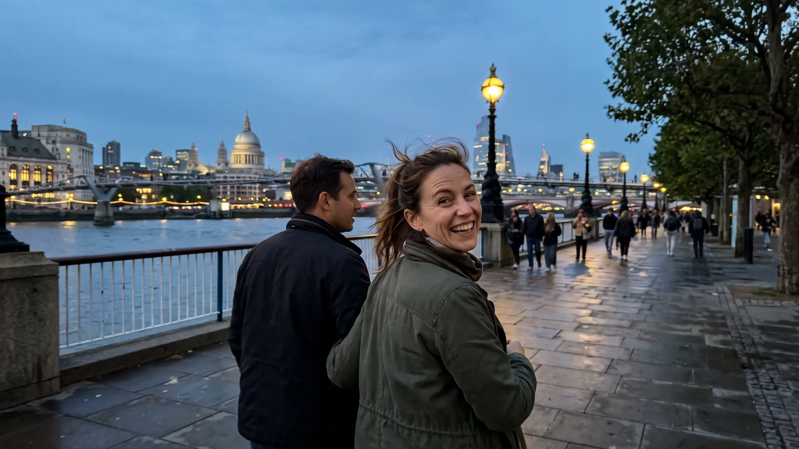 A couple strolls along the riverside walk on the South Bank at dusk, St Paul's Cathedral and the lit north bank across the Thames behind them (AI-generated image)