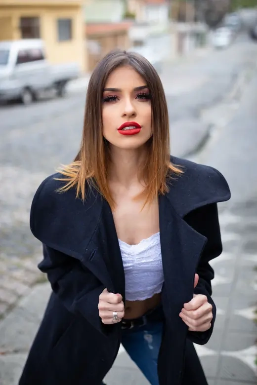 A woman looking directly at the camera on a city street