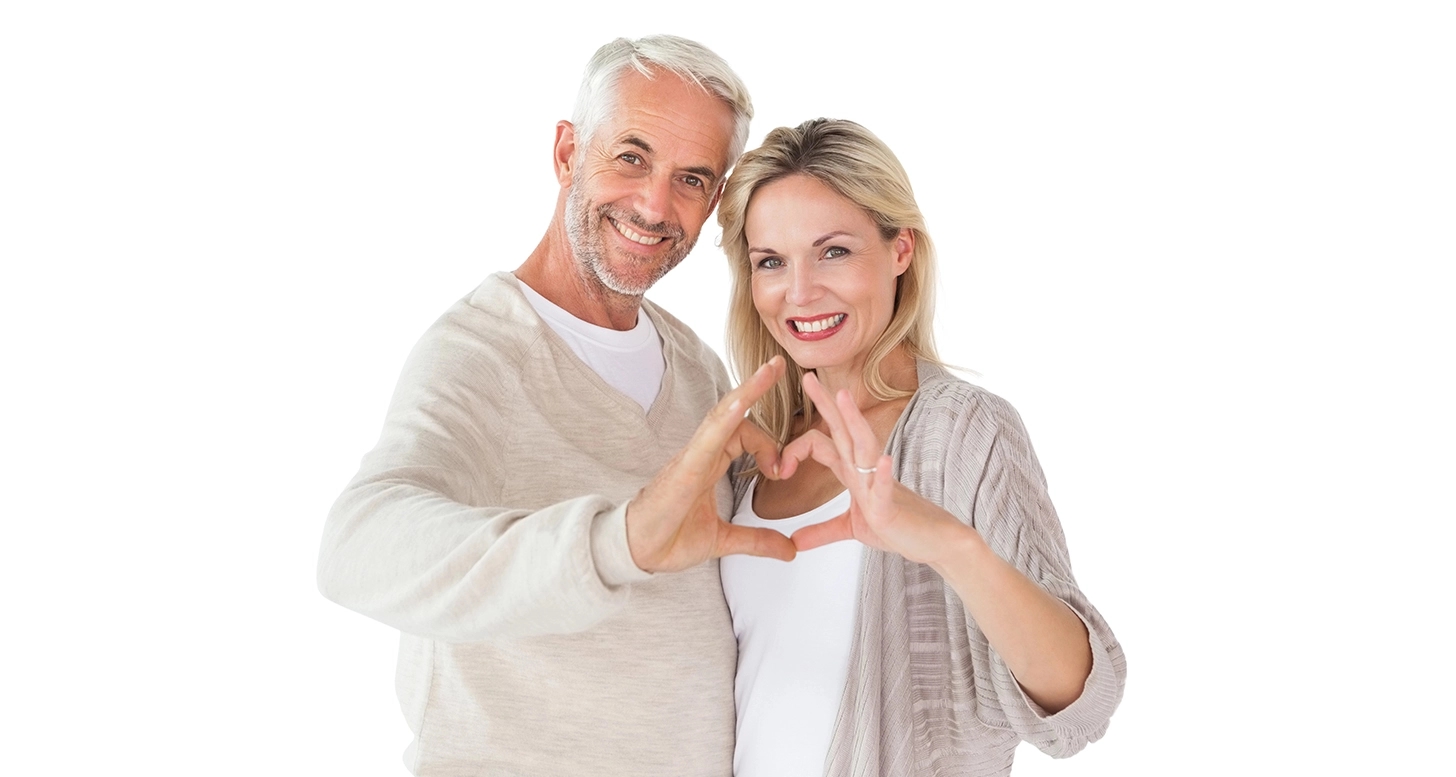Mature couple laughing and enjoying wine at dinner