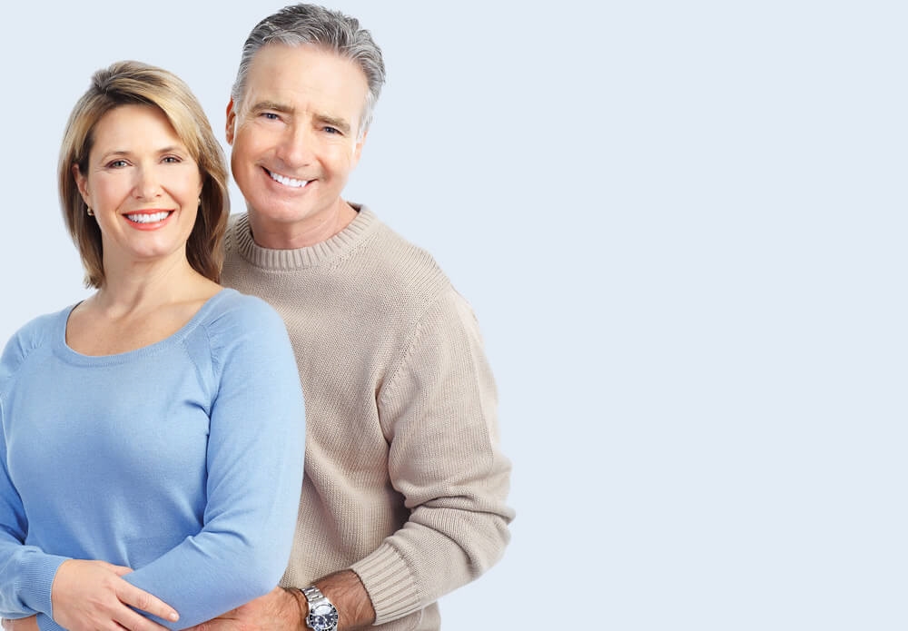 A smiling older couple standing together