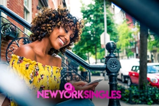 A smiling person setting up a dating profile on a smartphone with a New York City backdrop.