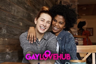 Two gay singles smiling while chatting on the Gay Love Hub dating platform.