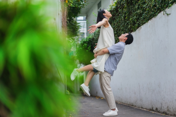 Couple laughing and playing together outdoors