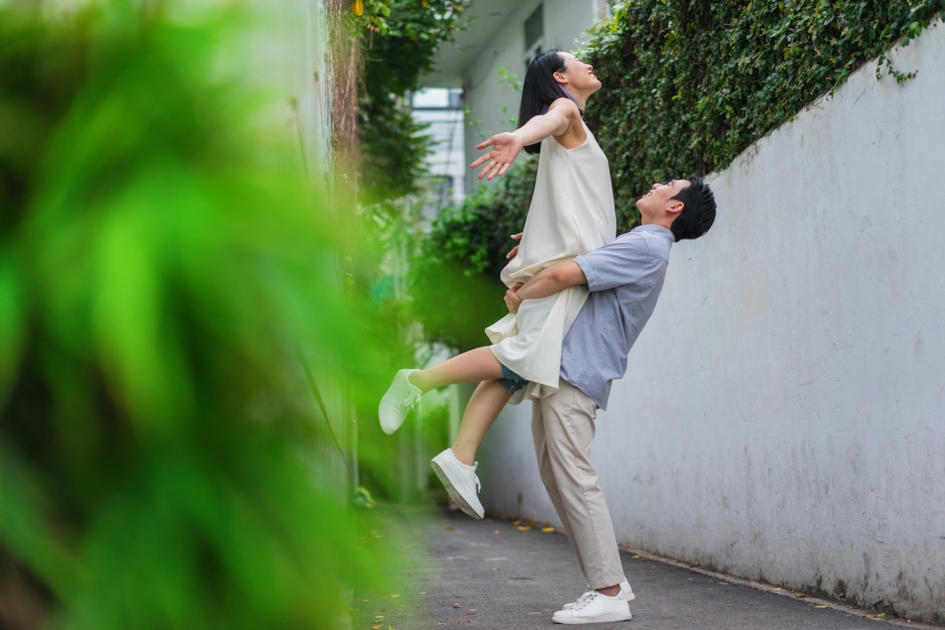 Couple laughing and playing together outdoors