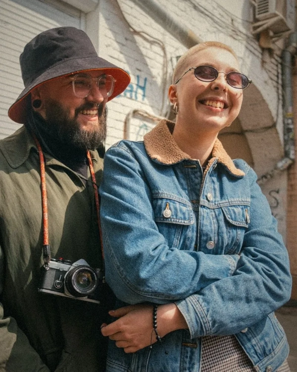 Smiling couple with a film camera