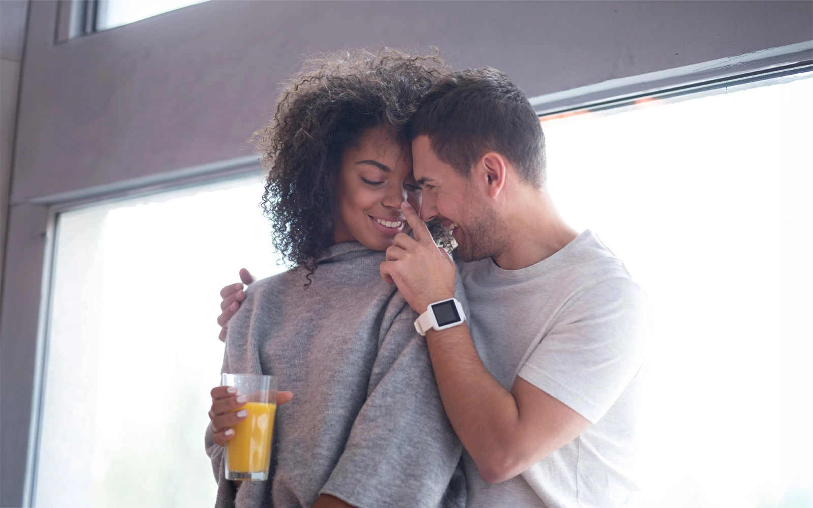 Black and white interracial couple embracing outdoors