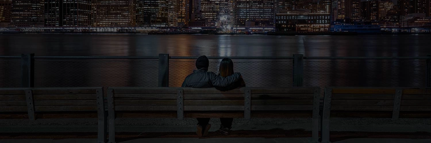 Couple overlooking the busy New York City skyline.