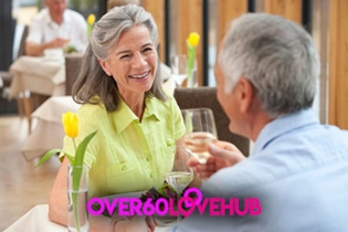 Happy over 60 singles couple enjoying a glass of wine on a date