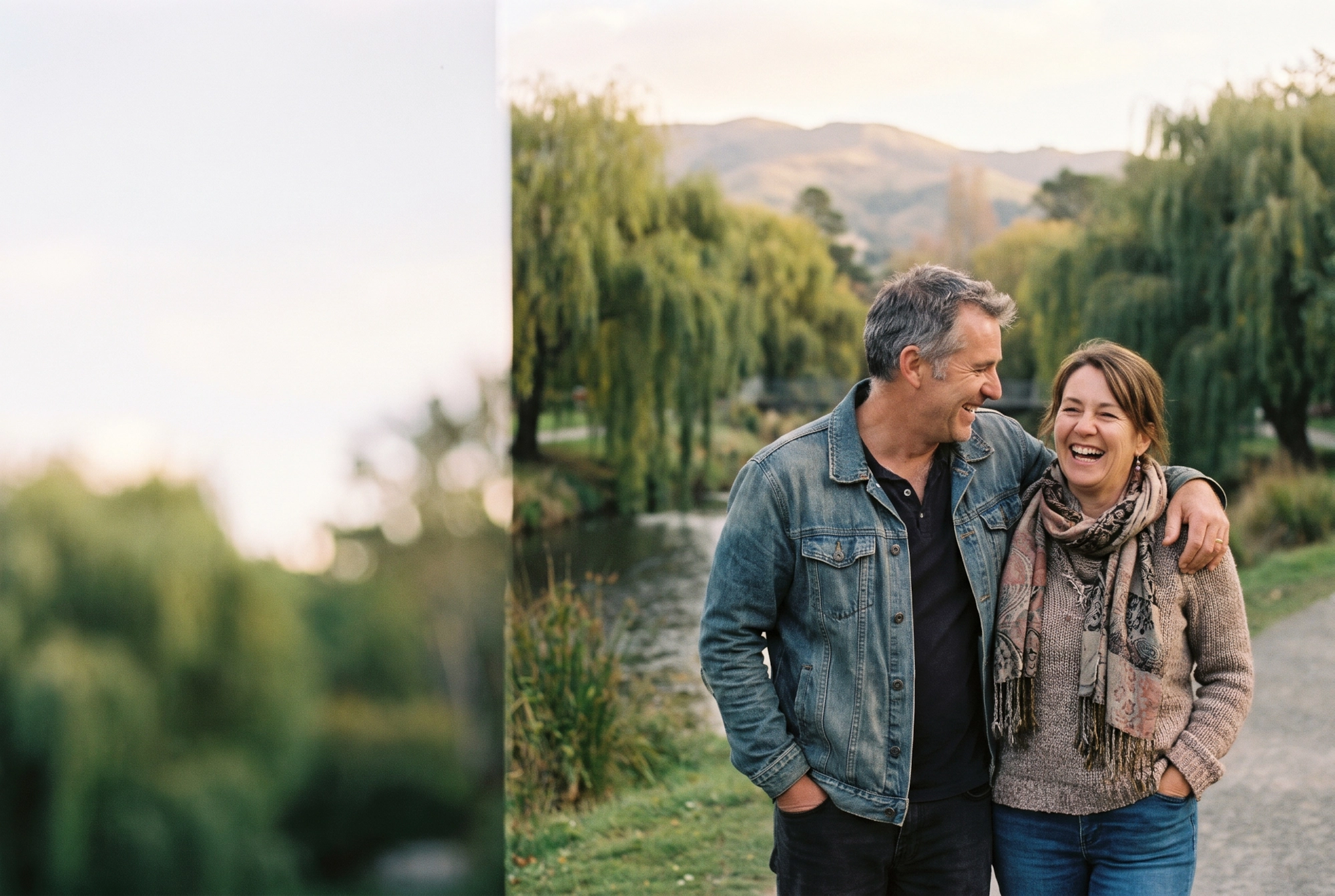 A happy couple laughing together in the Christchurch Botanic Gardens by the Avon River