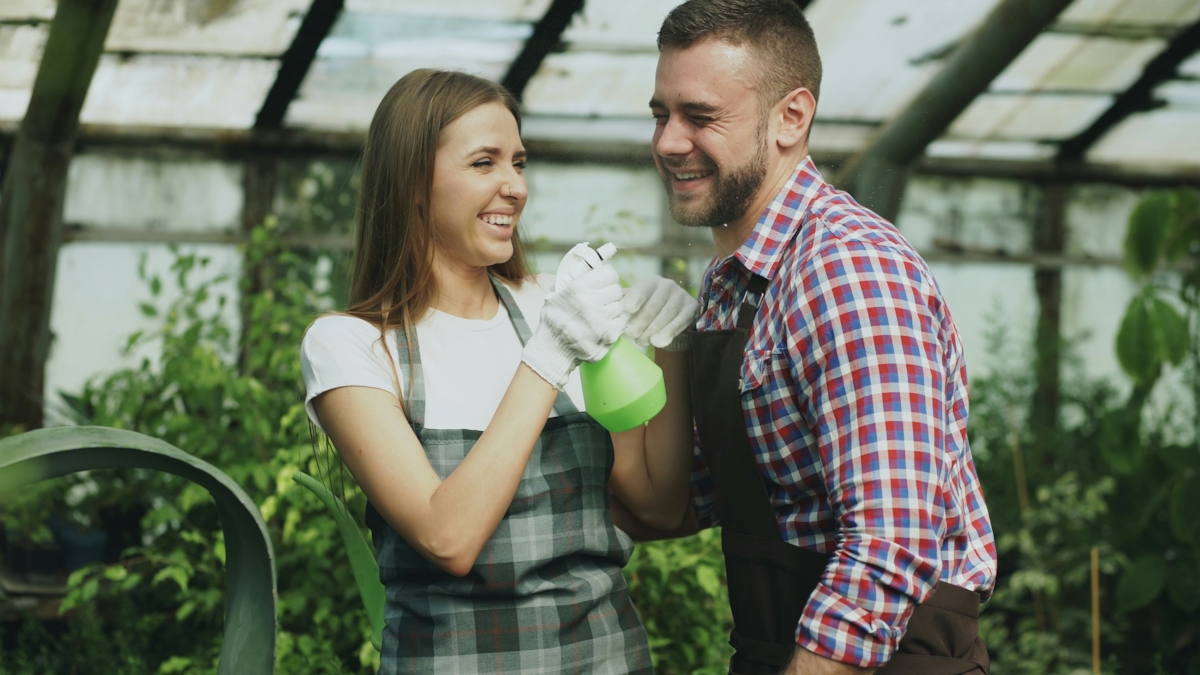 A couple gardening together outdoors, working side by side in a relaxed, everyday moment