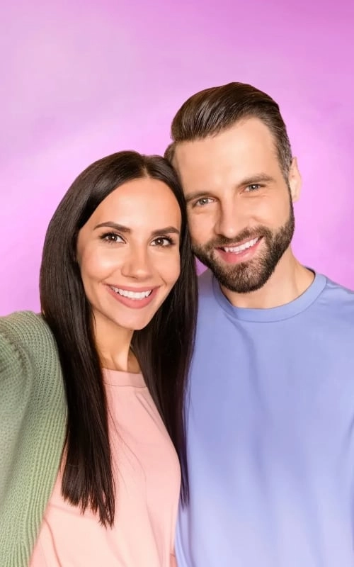 A smiling couple taking a selfie together
